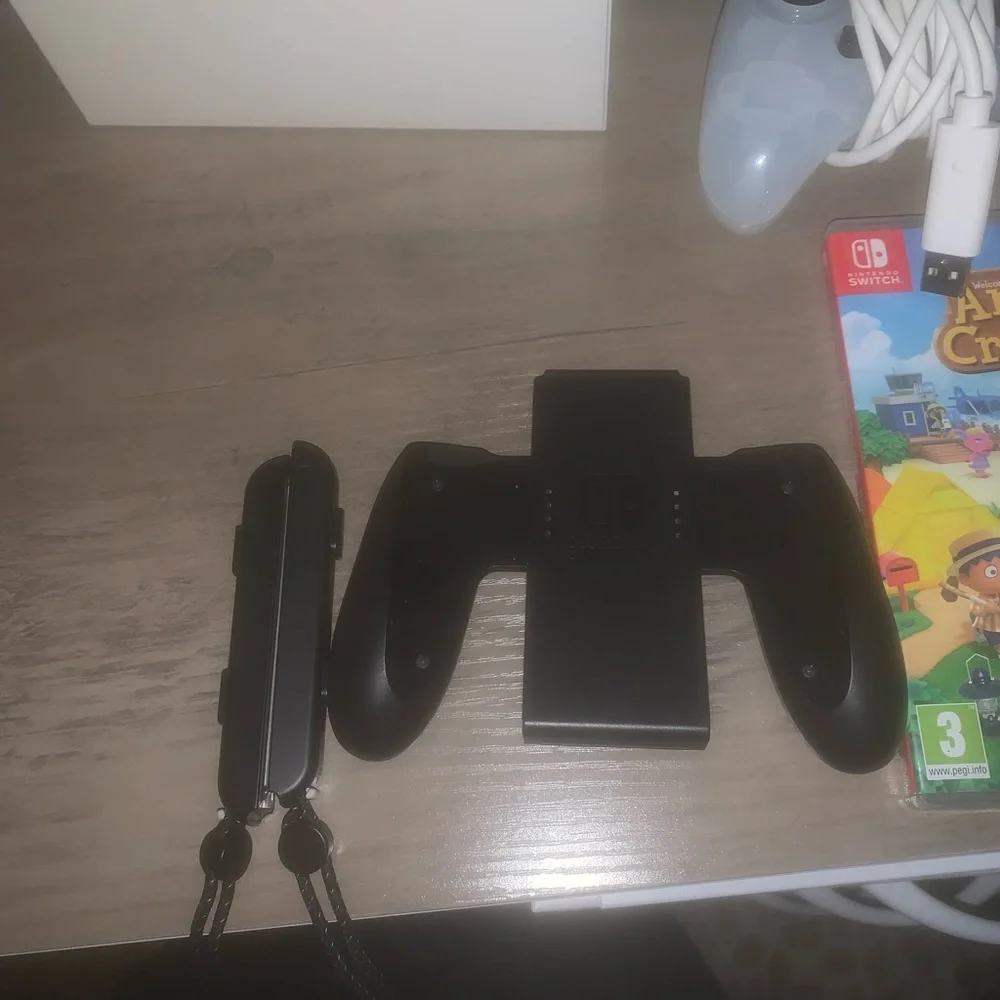 Nintendo Console with White and Black Controllers